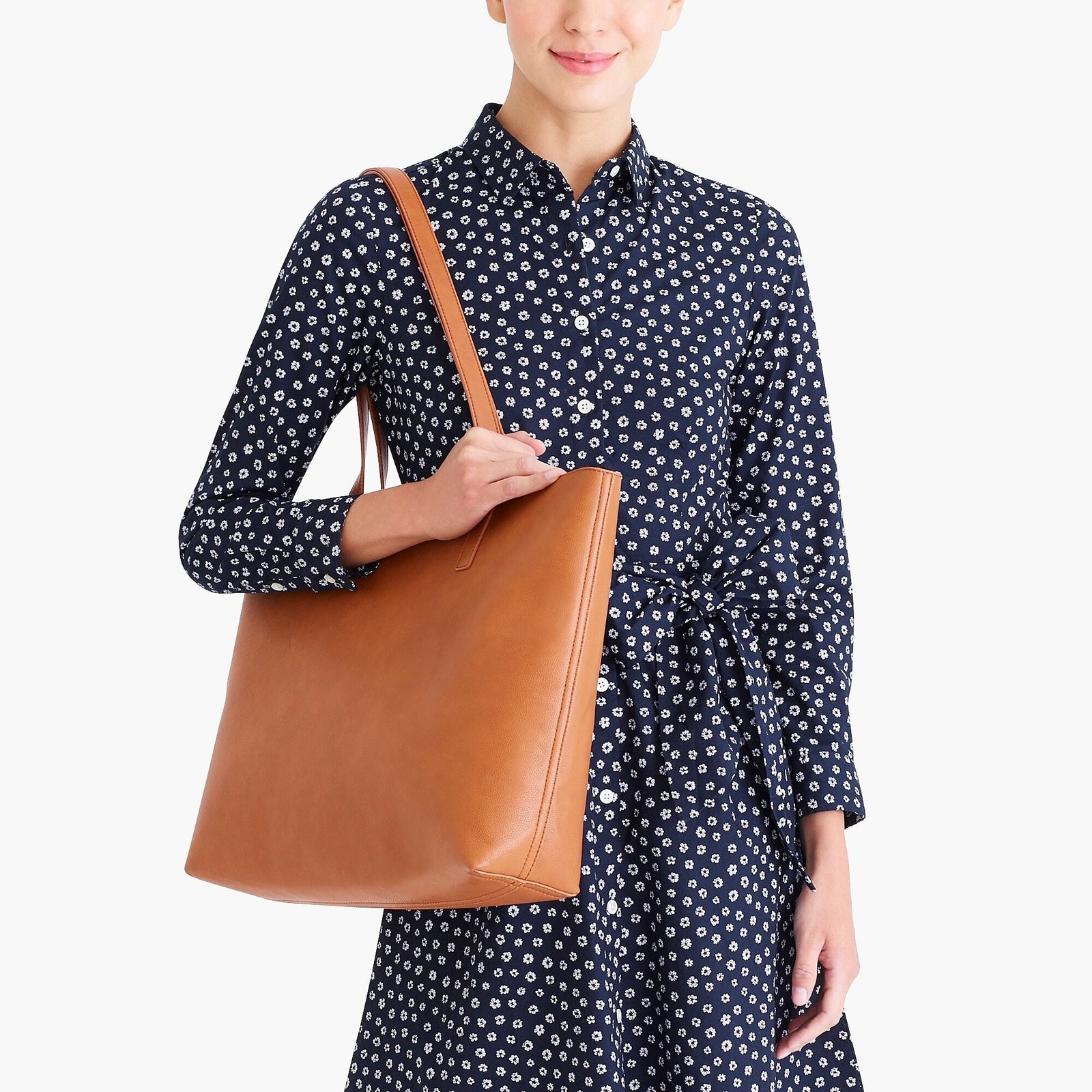 Promising review: "I bought this bag to use and abuse everyday and for travel so I can throw a bunch of stuff in and not worry. The straps are nice and long, the bag has a zipper, it’s huge, has an inside pocket, and the inside is also a shiny faux leather that makes it easy to clean. At this price point, it’s a no brainer!" —AypayGet it from J.Crew Factory for $46.50 (available in two colors).