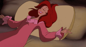 ariel from the little mermaid cuddling up with her pillow