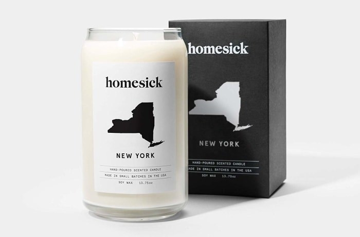 a new york homesick candle with the shape of the state on it