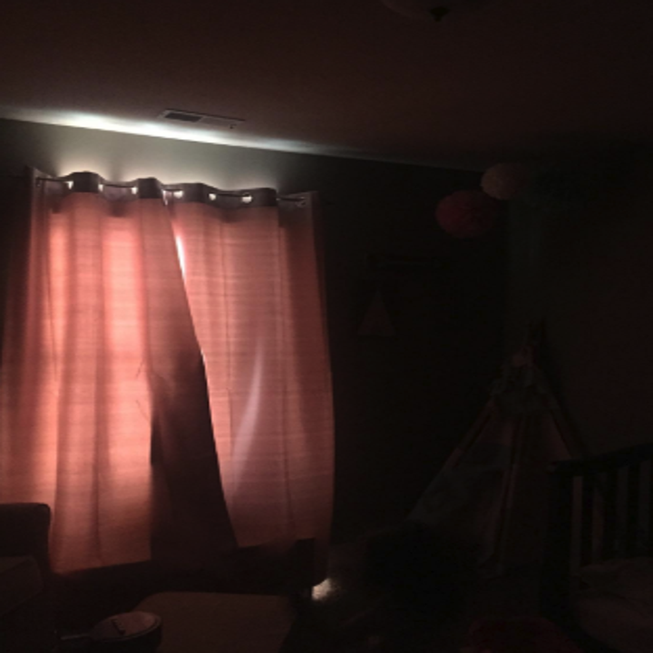 a reviewer photo showing how the pink curtains block out light