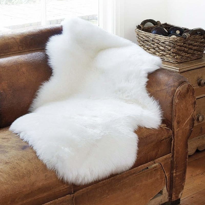 White faux sheepskin rug on a couch