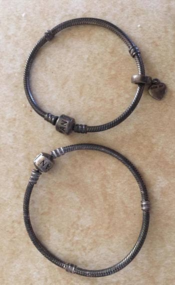 A reviewer photo of bracelets that are dark with tarnish