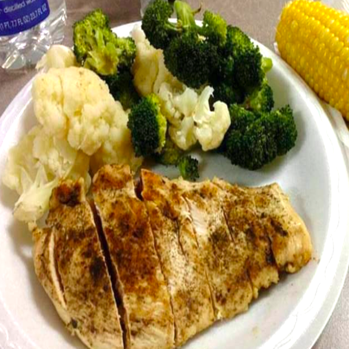 A reviewer's plate of their steamed fish and veggies