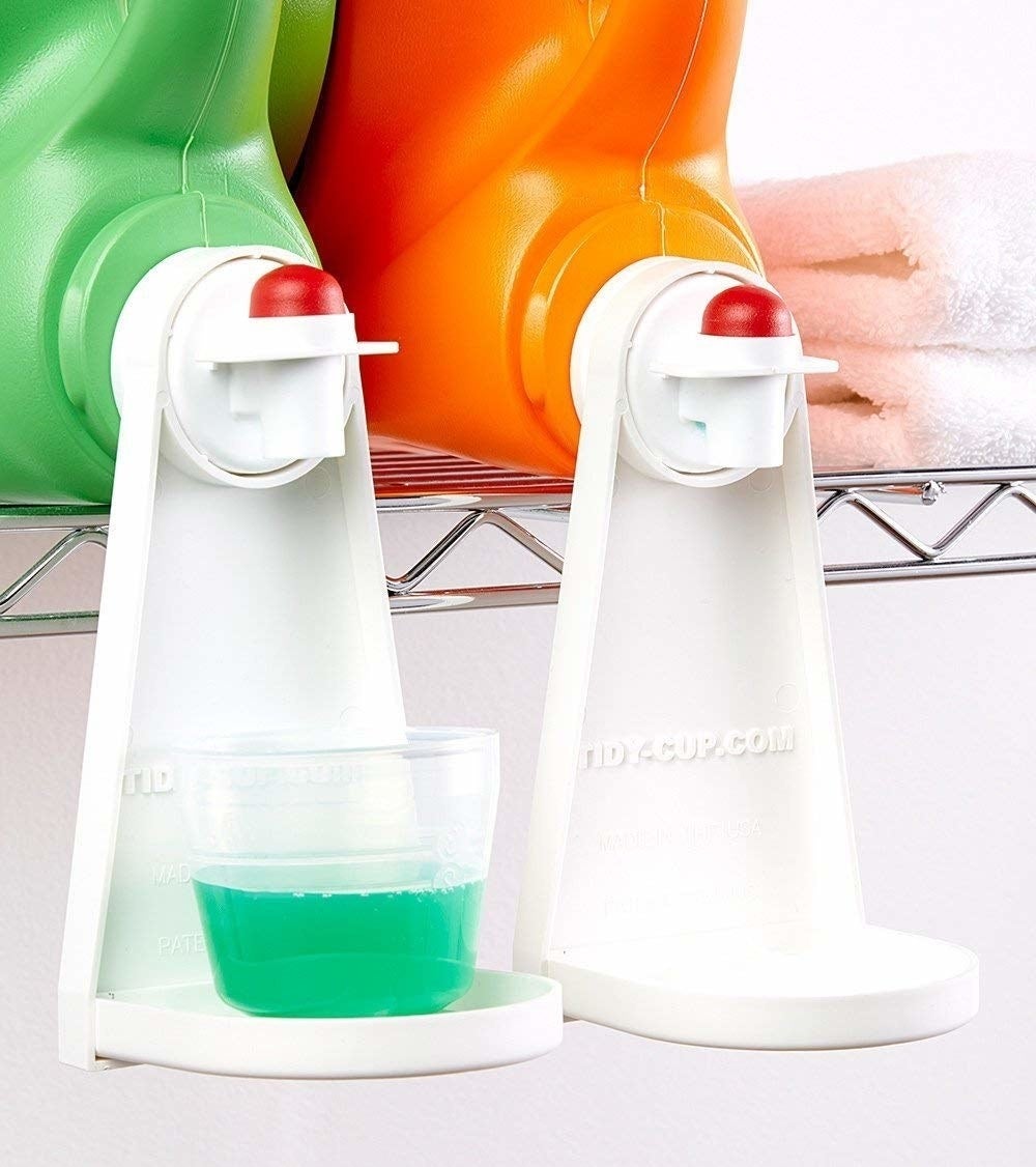 The drip catcher attached to the detergent bottle, which offers a ledge for the cup