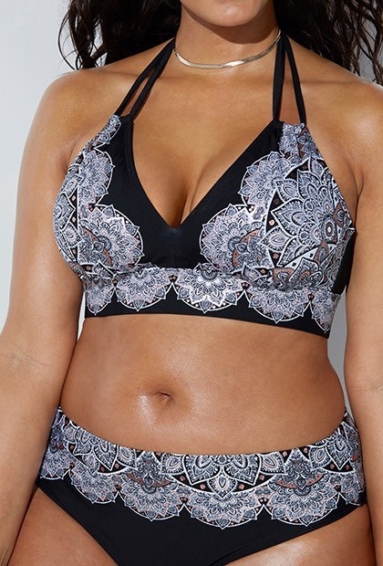 a mode in a matching top and bottom: the top is black, v-neck, with a white mandala-like design on it
