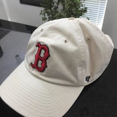 same reviewer showing their baseball cap completely cleaned after using the cap cage