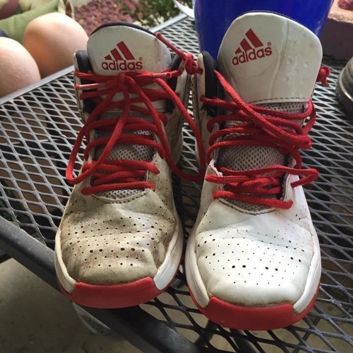 reviewer photo showing one of their Adidas sneakers dirty, and the other completely cleaned after using the cleaner 