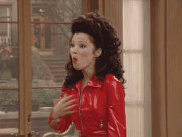Fran Drescher in the tv show &quot;The Nanny&quot; grabbing her chest and opening her mouth in surprise and wonder
