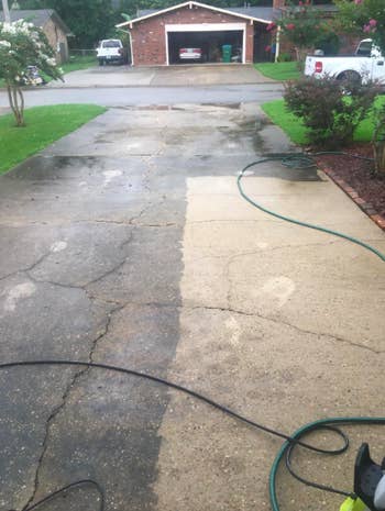 reviewer image of a driveway half cleaned with the sun joe pressure washer; the left side is dark and dirty, and the right side is clean and beige