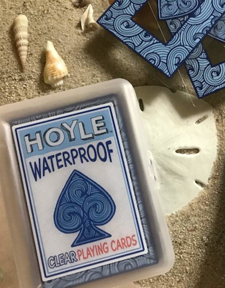 waterproof playing cards laying in the sand