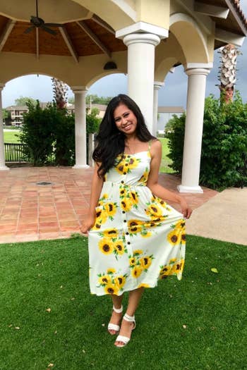 A reviewer in the button-front dress in the white with sunflowers print