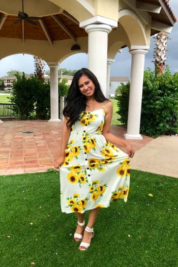 A reviewer in the button-front dress in the white with sunflowers print