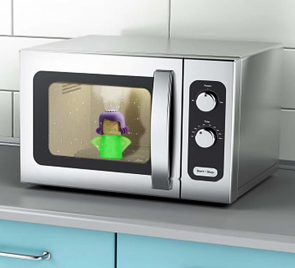 The microwave cleaner is actually a small bottle shaped like a woman&#x27;s shoulders and head. Her head has tiny holes where the cleaning concoction will spurt from to clean the microwave. It&#x27;s sitting inside of a microwave.