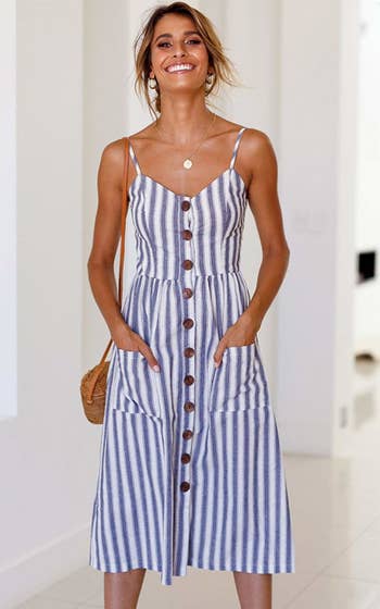 A model wearing the spaghetti-strap dress in blue and white stripes
