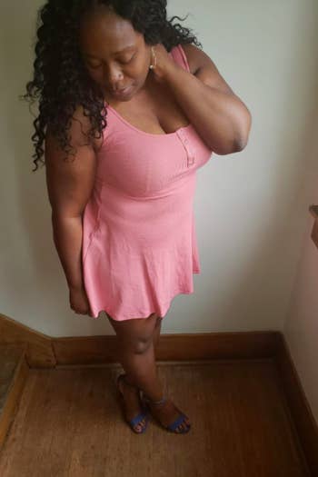 A reviewer wearing the sleeveless mini dress in pink