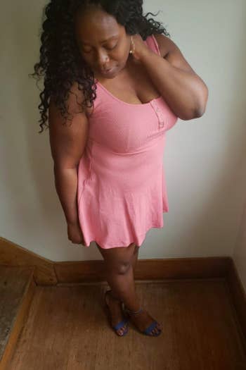 A reviewer wearing the sleeveless mini dress in pink