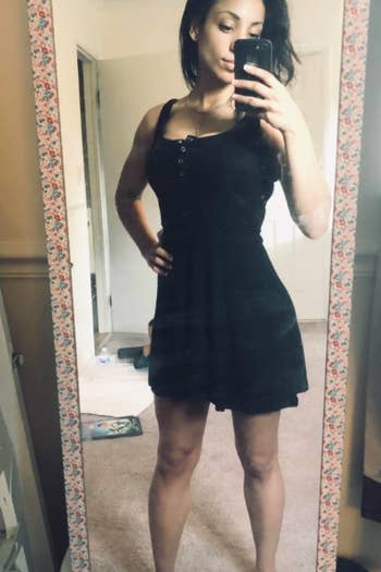 A reviewer wearing the dress in black