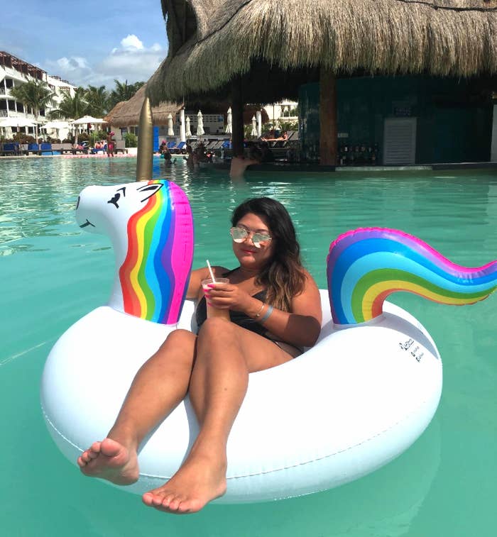 Reviewer sitting in pool float holding their drink