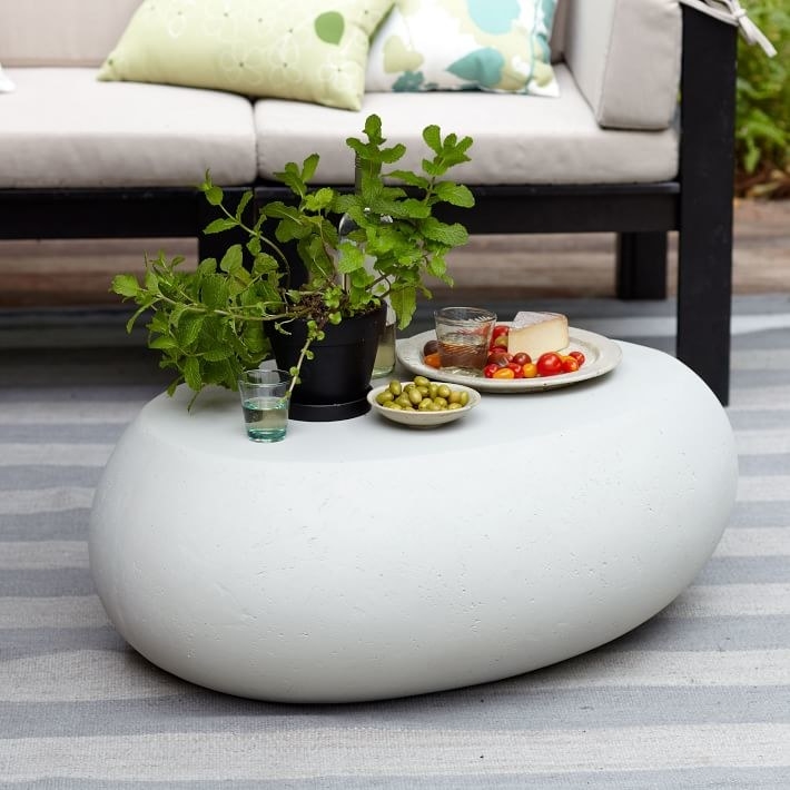 the white pebble outdoor table with food on it