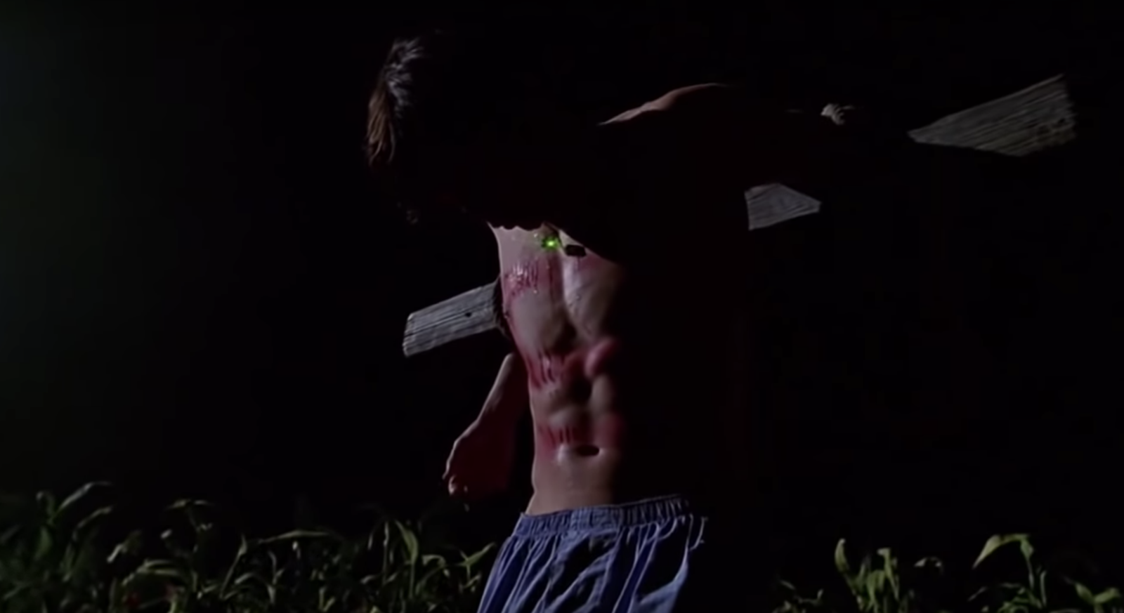 Tom Welling hanging from a cross shirtless