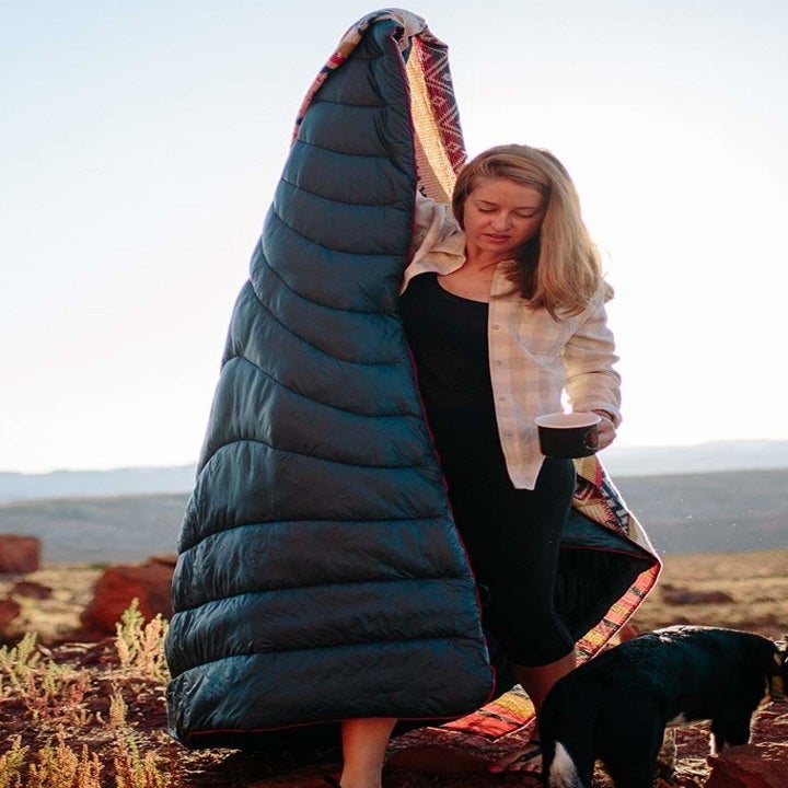 model holding blanket outdoors