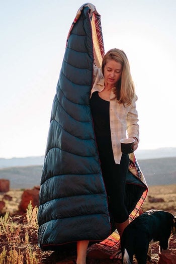 model holding blanket outdoors