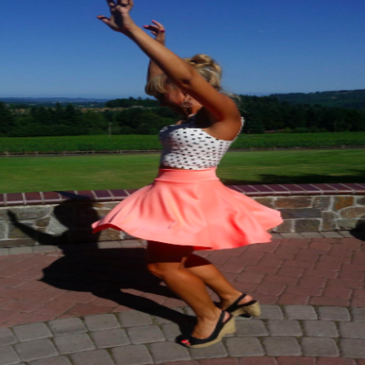 a reviewer twirling in the skirt in pink
