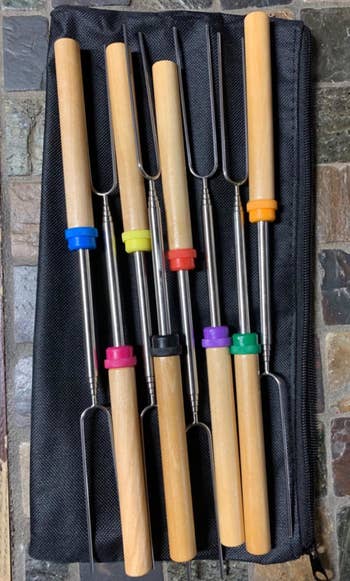 metal skewers with wood handles that each have a different color ring around them