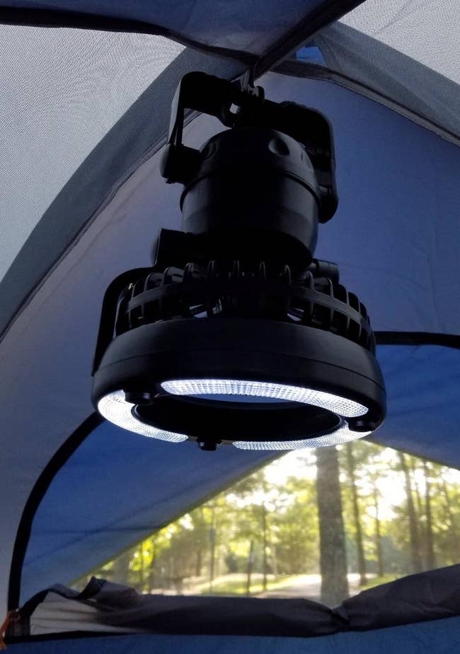 reviewer pic of the light and fan combo hanging inside a tent