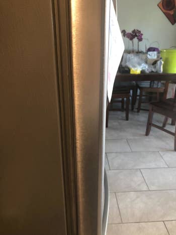 Reviewer photo showing sticky residue completely removed from fridge door
