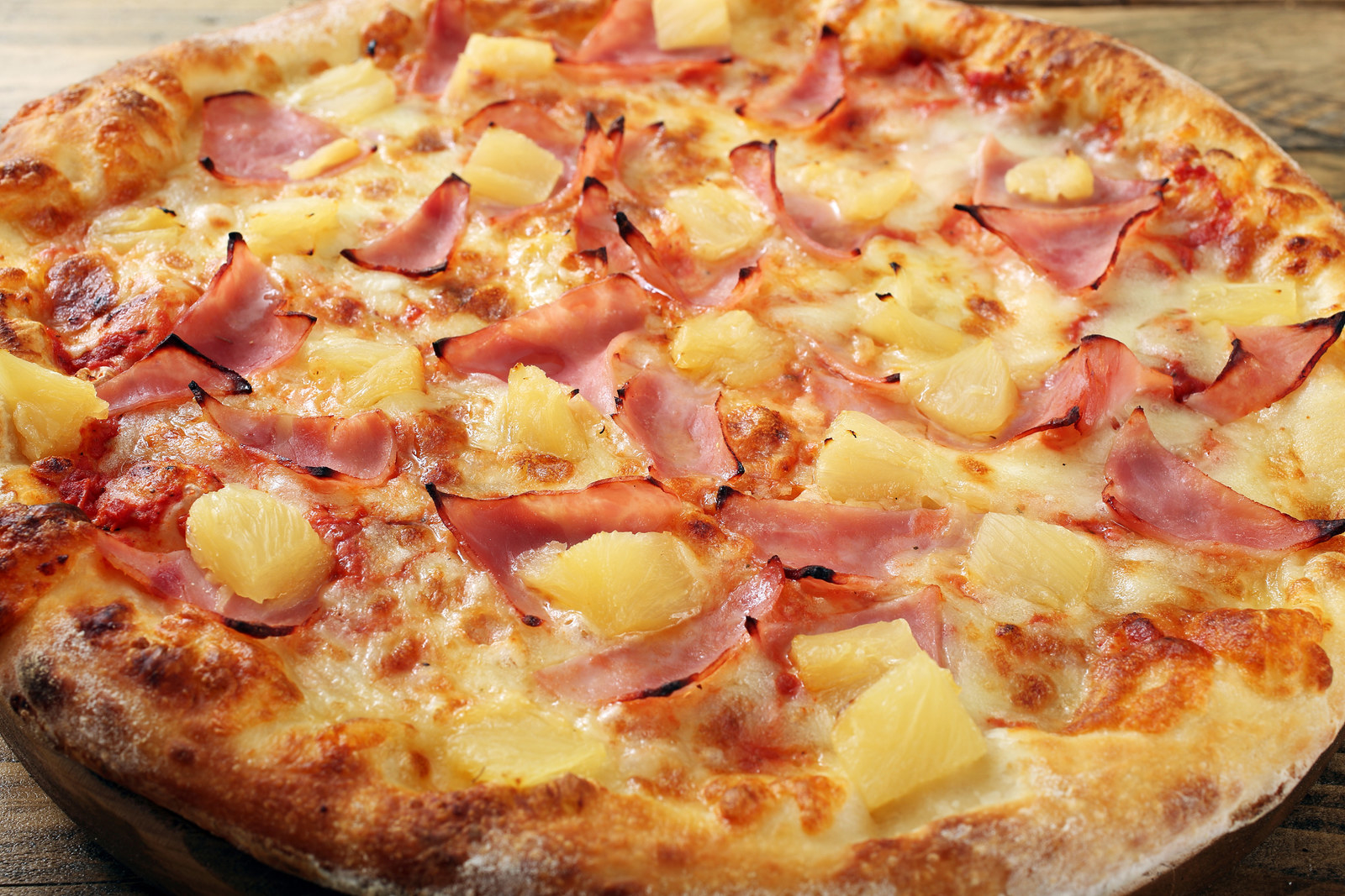 Pizza with pineapple and ham on it