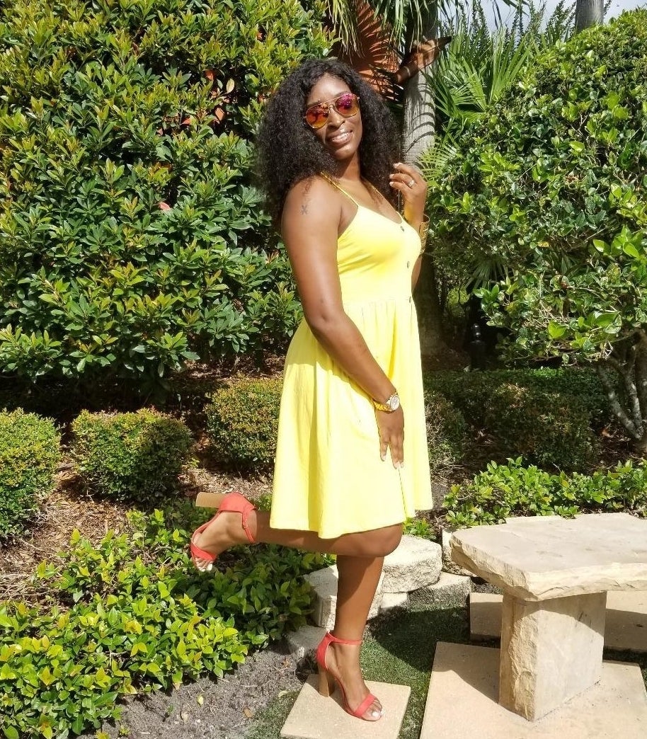 Reviewer wearing the strappy dress in yellow