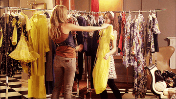 Gif of Serena and Blair from Gossip Girl standing in front of a rack of clothes