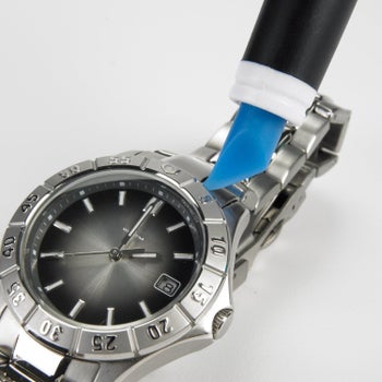 The rubber chisel tip getting crud out of a metal watch