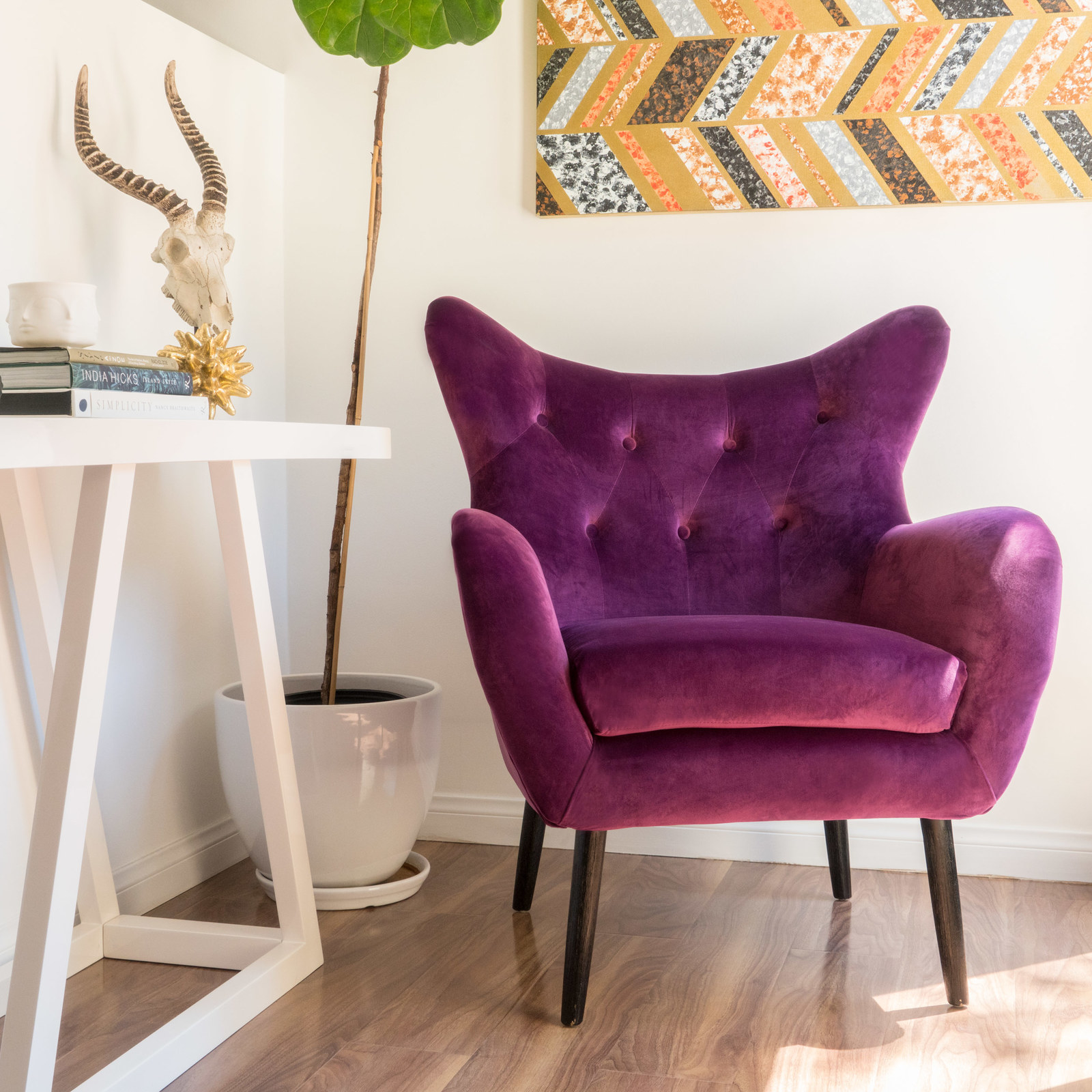 photo of butterfly velvet purple armchair in the corner of room