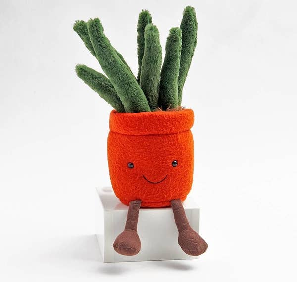 plush potted plant with small on pot and two legs 