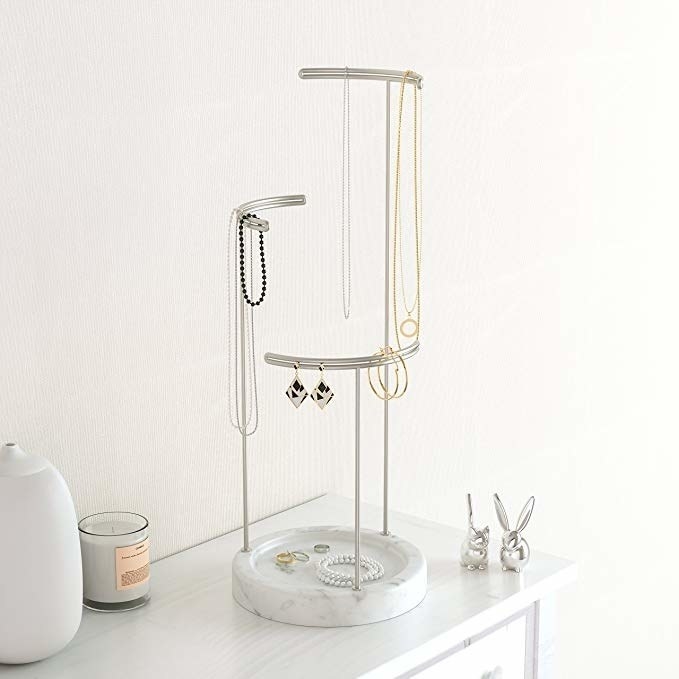 Marble based jewelry stand with three narrow metal posts for hanging jewelry 