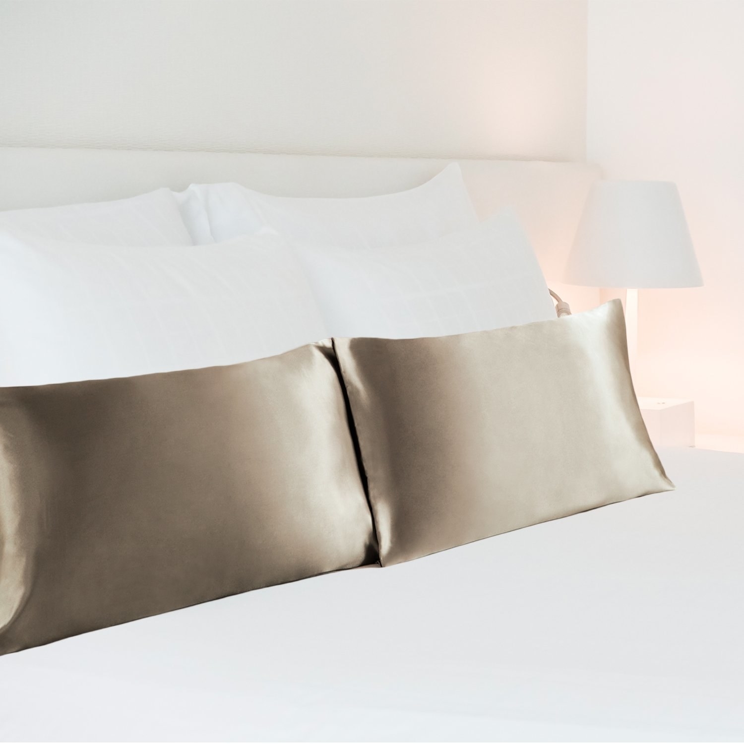 Two gold satin pillowcases on a bed