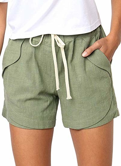 a model wearing olive green shorts with an off white draw string waist and pockets