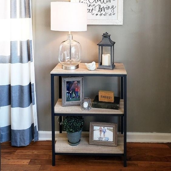 The light wood and black metal bookcase with two shelves