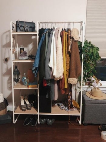 white metal rack with four shelves on the left and space for hanging longer garments on the right