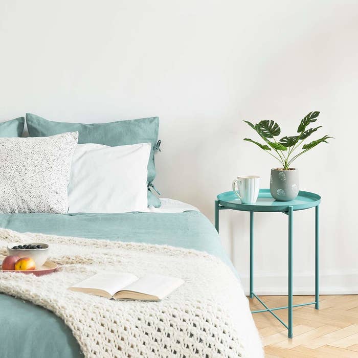 The blue metal side table with circular surface