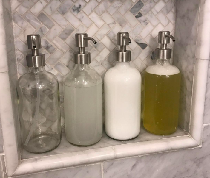 A customer review photo of four soap dispensers in their shower