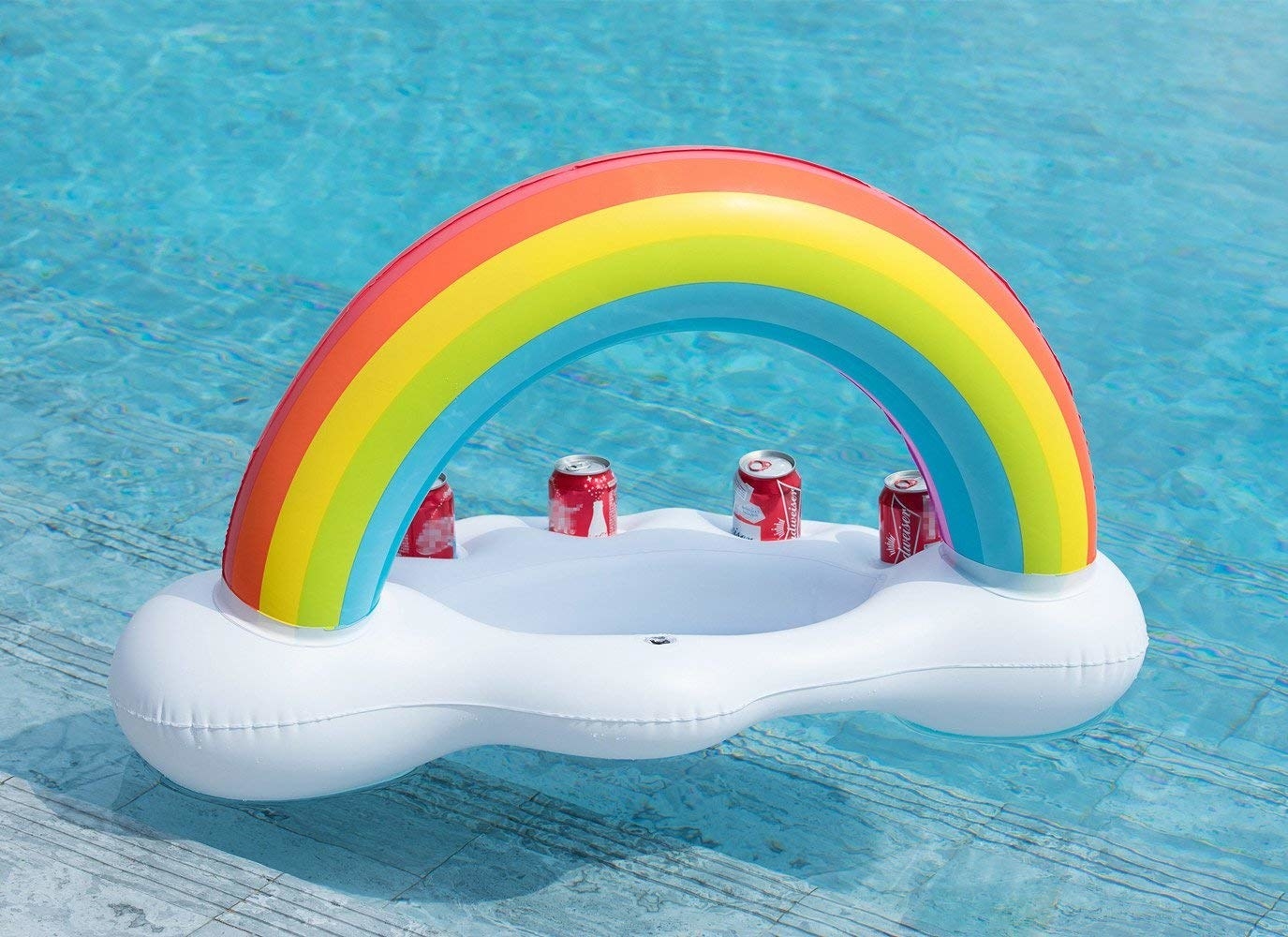 a rainbow blow up float attached to a cloud that acts as a cooler
