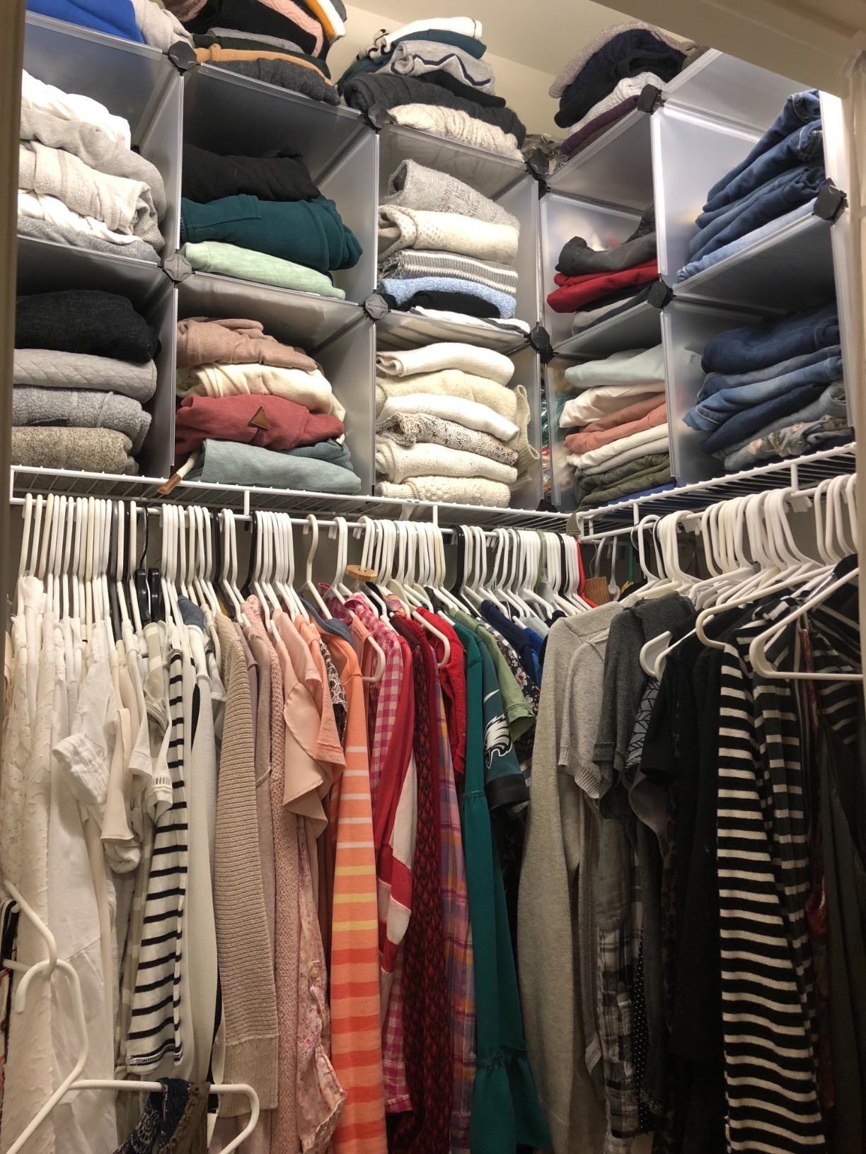 Reviewer photo of a closet with the cubs on the top shelf, making room to store way more clothes
