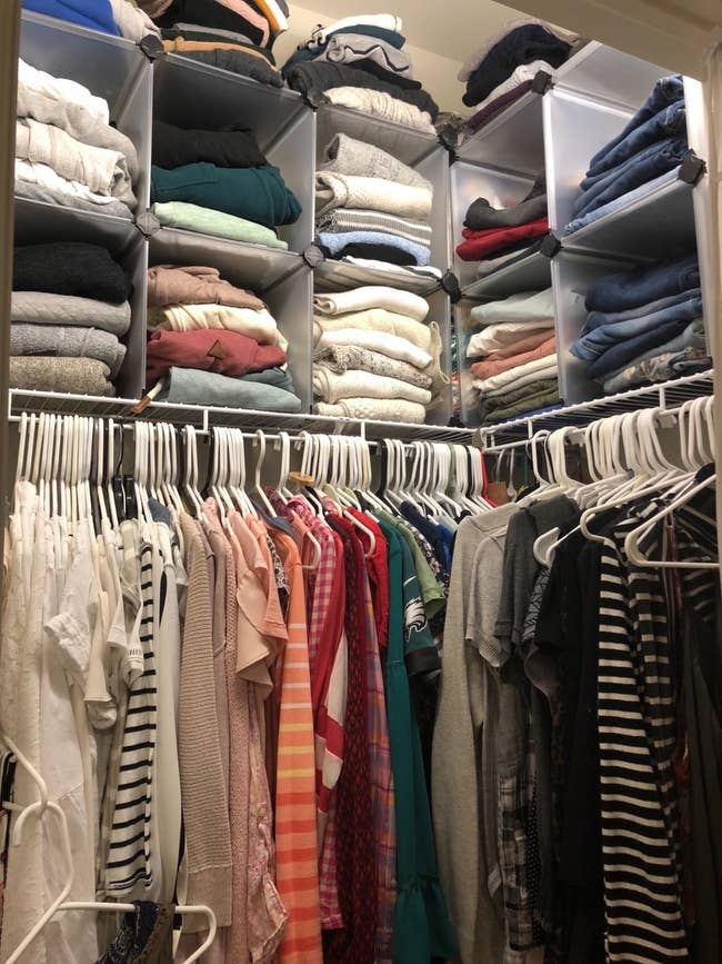Reviewer photo of a closet with the cubes on the top shelf, making room to store more clothes