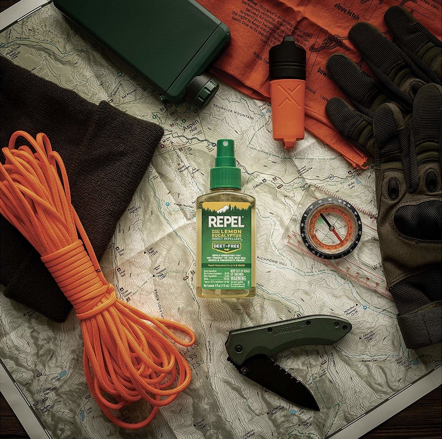 The spray bottle surrounded by camping gear