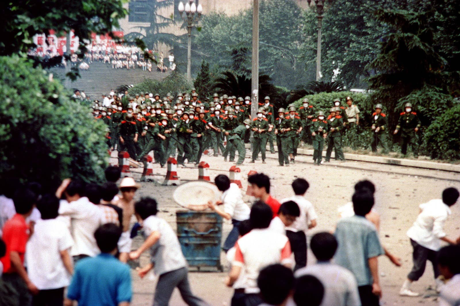 Chinese citizens hurl stones at troops, June 4.