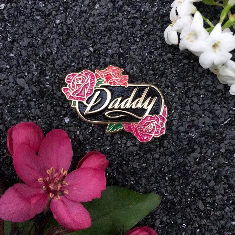the Daddy pin with golden lettering and pink roses
