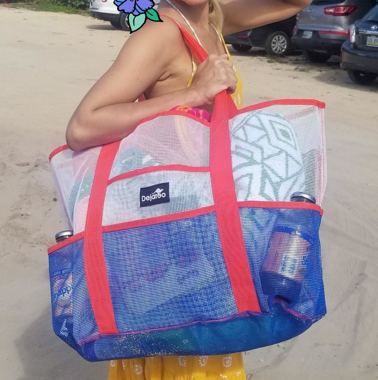 reviewer holding pink white and blue beach bag made of mesh